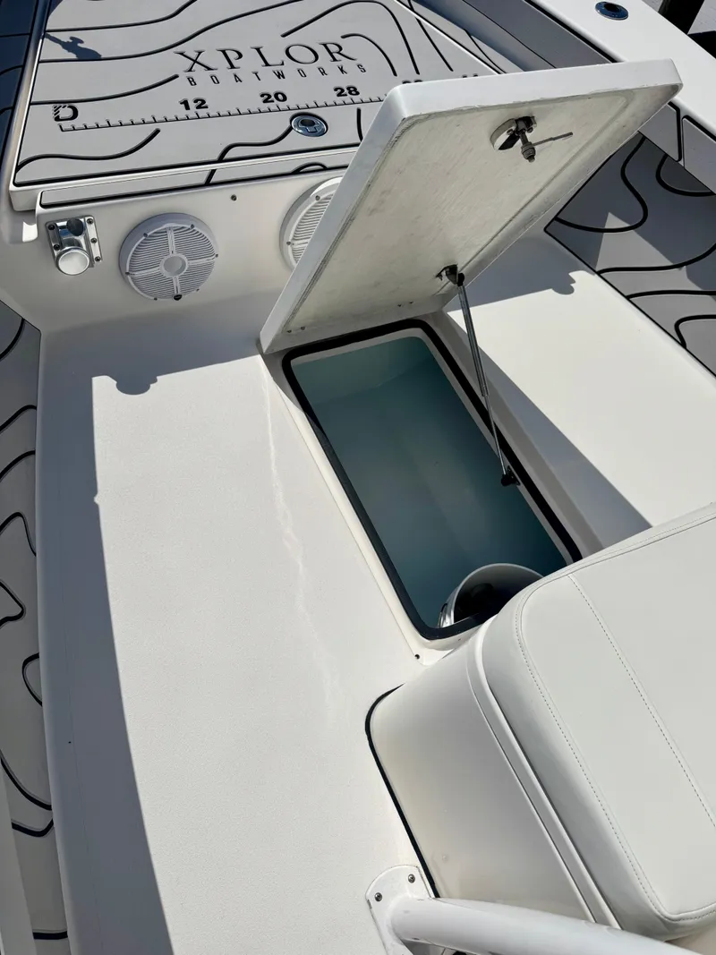 Slide: The Image of 2022 Xplor x24 Andros Mercury boat interior with open storage compartment. - 20