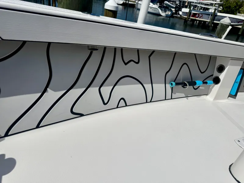 Slide: The Image of 2022 Xplor x24 Andros Mercury 300 boat interior with modern design and marina background. - 21