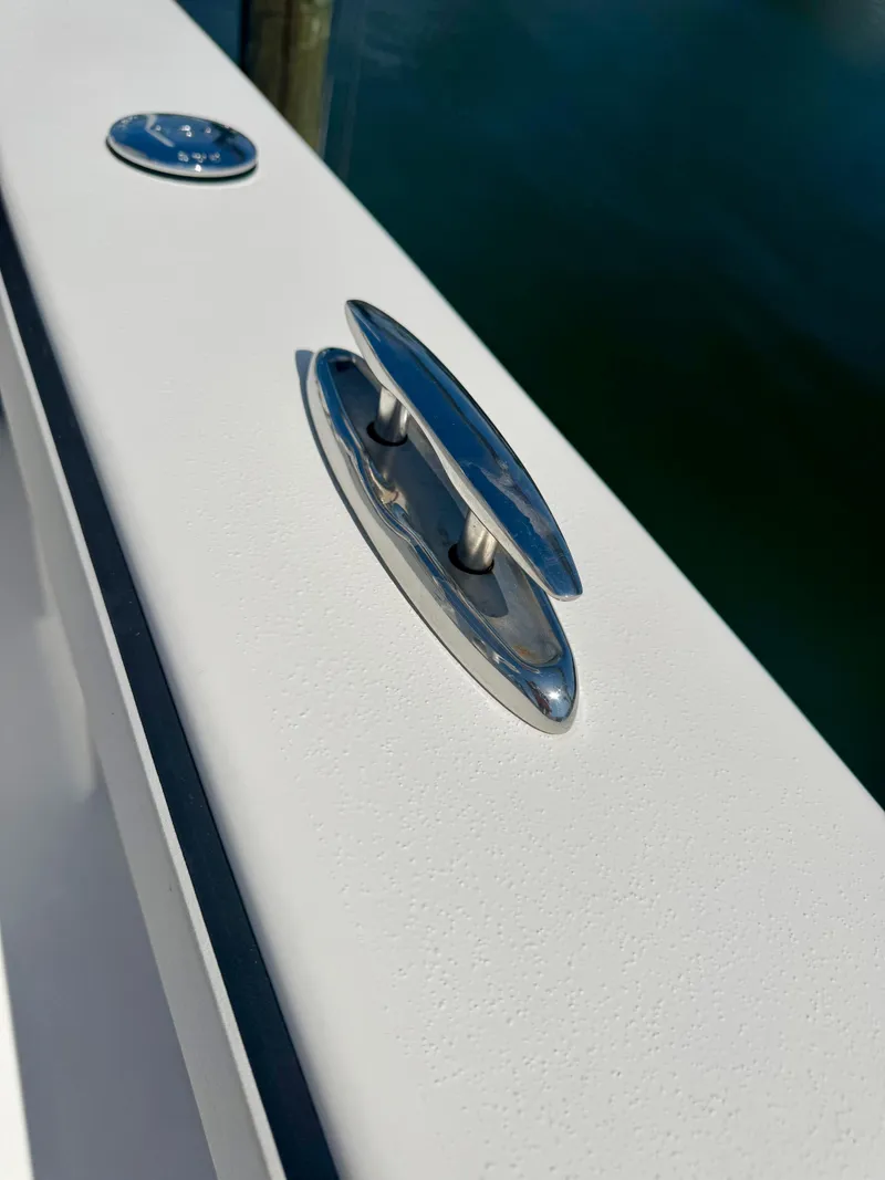 Slide: The Image of 2022 Xplor x24 Andros Mercury boat cleat detail, sleek design, stainless steel finish. - 23