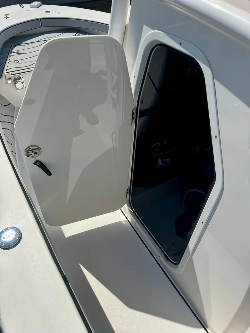 Slide: The Image of 2022 Xplor x24 Andros Mercury boat with open storage compartment and sleek design. - 24