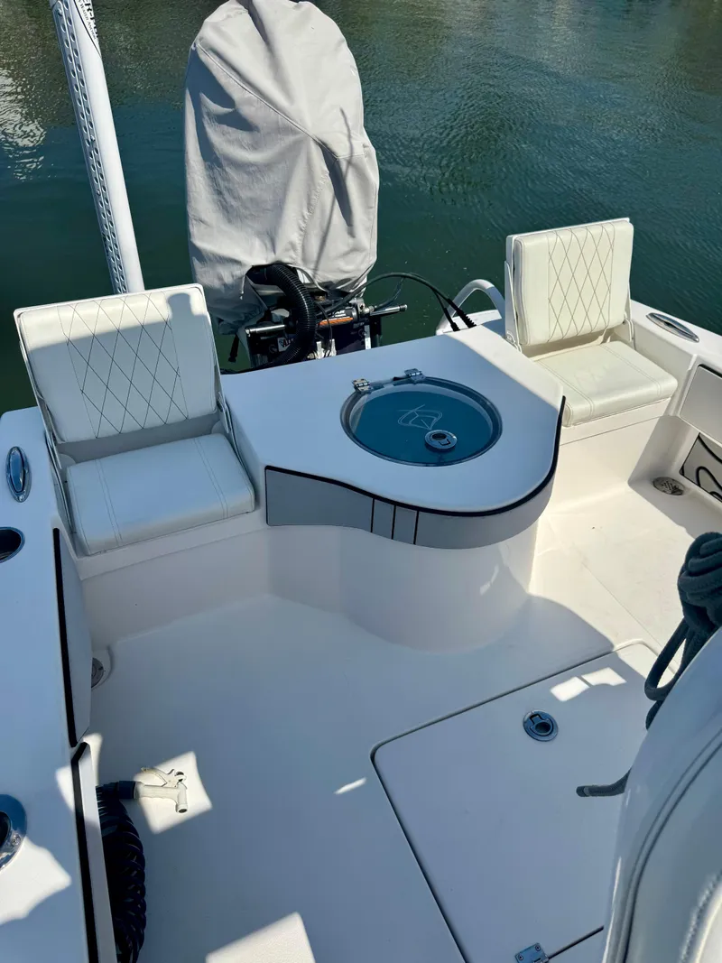 Slide: The Image of 2022 Xplor x24 Andros Mercury boat interior with seating and covered engine. - 29