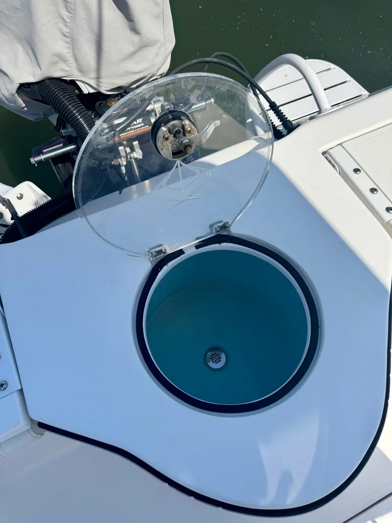 Slide: The Image of Livewell on 2022 Xplor x24 Andros Mercury 300 boat, open lid, blue interior. - 30