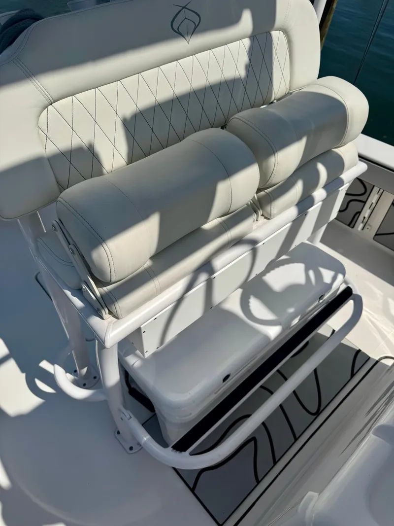 Slide: The Image of 2022 Xplor x24 Andros Mercury boat seat with white upholstery and storage compartment. - 35