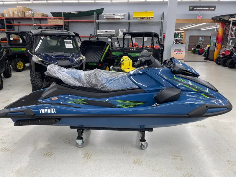 Slide: The Image of 2025 Yamaha WaveRunner VX Cruiser HO in showroom, blue with green accents. - 0