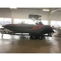 Slide: The Image of 2024 Starcraft MVX Surf boat on trailer in indoor showroom. - 0