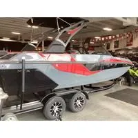 Slide: The Image of 2024 Starcraft MVX Surf boat in showroom, featuring sleek design and vibrant red accents. - 1