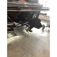 Slide: The Image of 2024 Starcraft MVX Surf boat's rear view with propeller and trailer. - 2