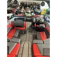 Slide: The Image of 2024 Starcraft MVX Surf boat interior with red and gray seating, showcasing spacious design. - 3