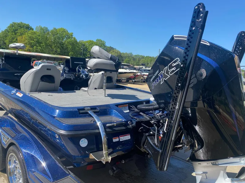 Slide: The Image of 2022 Nitro Z21 XL Pro boat with powerful engine, parked near a lake. - 6