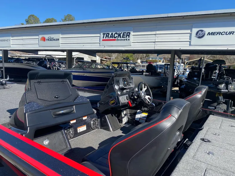 Slide: The Image of 2023 Nitro Z21 XL Pro boat interior at dealership with Tracker and Mercury signage. - 6