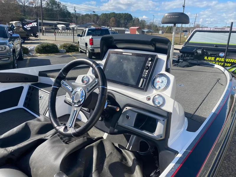 Slide: The Image of 2020 Nitro Z21 Pro boat dashboard with steering wheel and electronic display. - 7