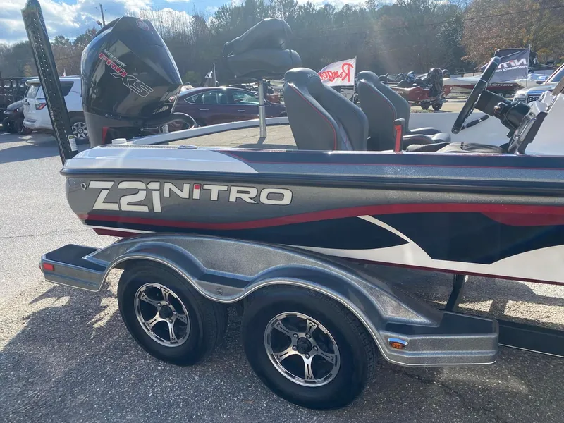 Slide: The Image of 2020 Nitro Z21 Pro boat with dual axle trailer in a parking lot. - 8
