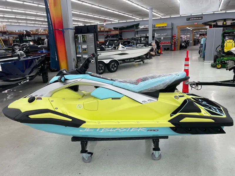 Slide: The Image of 2025 Yamaha WaveRunner JetBlaster PRO 3-Up in showroom, vibrant yellow and blue design. - 0