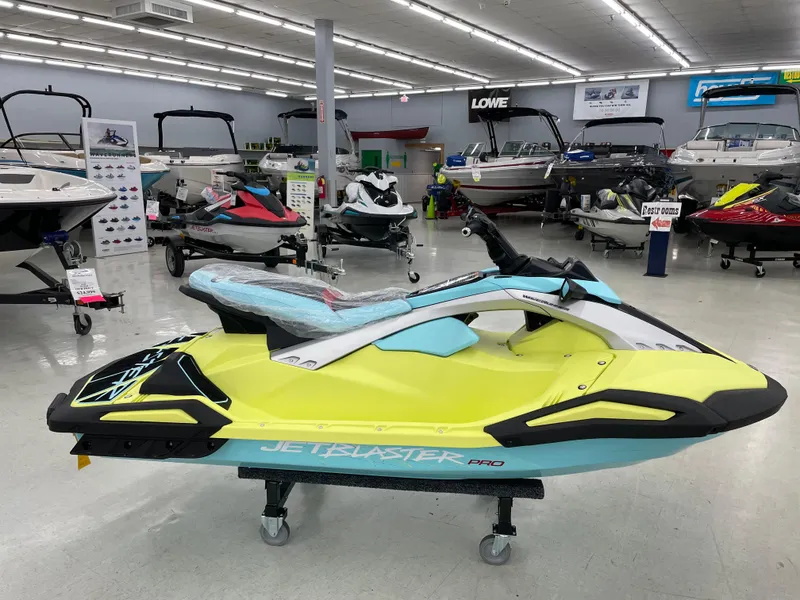 Slide: The Image of 2025 Yamaha WaveRunner JetBlaster PRO 3-Up in showroom, vibrant yellow and blue design. - 1