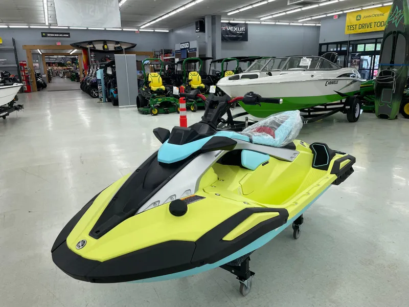 Slide: The Image of 2025 Yamaha WaveRunner JetBlaster PRO 3-Up in showroom, vibrant yellow and blue design. - 2