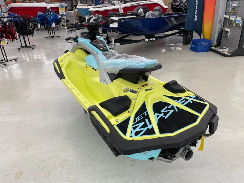 Slide: The Image of 2025 Yamaha WaveRunner JetBlaster PRO 3-Up in showroom, vibrant yellow and blue design. - 7