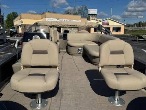 Slide: The Image of 2025 Sun Tracker Bass Buggy 18 DLX pontoon boat with beige seating and spacious deck. - 4
