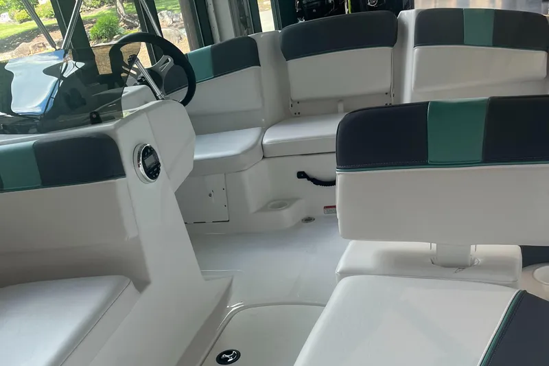 Slide: The Image of Interior of 2025 Tahoe T16 boat with white and teal seating arrangement. - 1