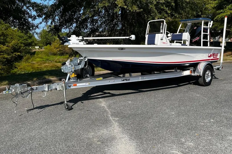 The Image of 2025 Mako Pro Skiff 18 Patriot Edition on trailer, parked outdoors. - 1