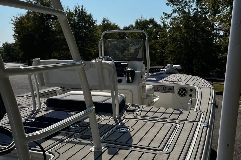 Slide: The Image of 2025 Mako Pro Skiff 18 Patriot Edition boat with sleek deck design and modern controls. - 5