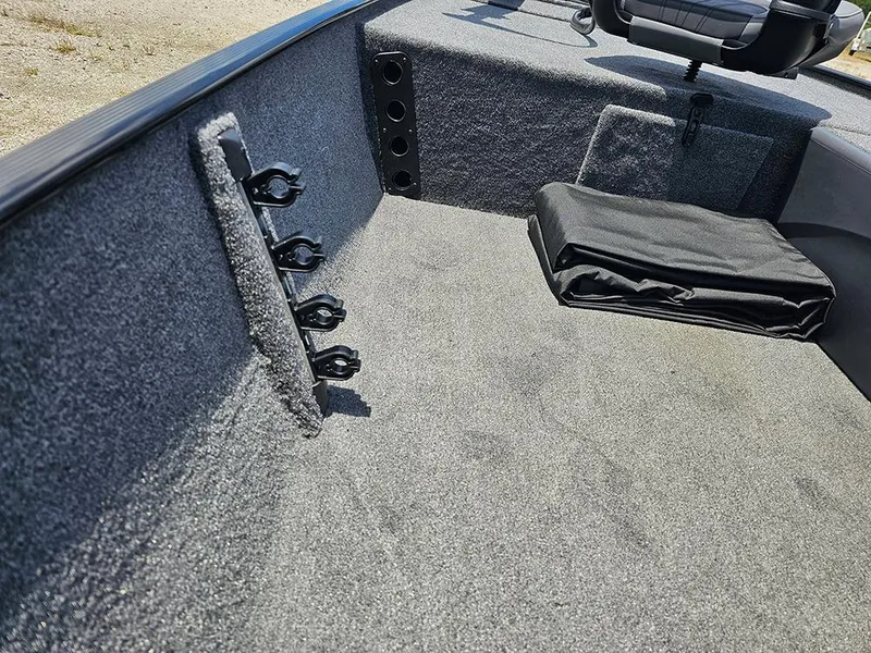 Slide: The Image of 2025 Tracker Bass Tracker Classic XL interior with carpeted storage and seating area. - 15