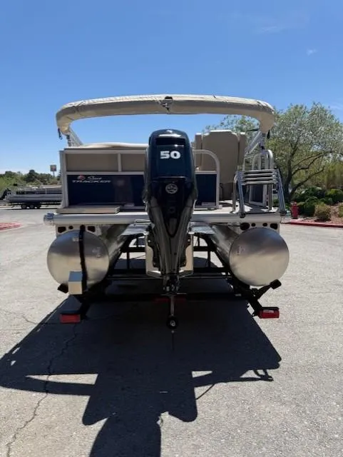 Slide: The Image of 2025 Sun Tracker Bass Buggy 16 XL Select pontoon boat with 50 HP motor, rear view. - 5
