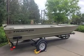 The Image of 2025 Tracker GRIZZLY 2072 Utility boat on trailer, parked outdoors. - 0