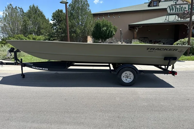 The Image of 2025 Tracker Grizzly 2072 Utility boat on trailer, parked outdoors. - 0