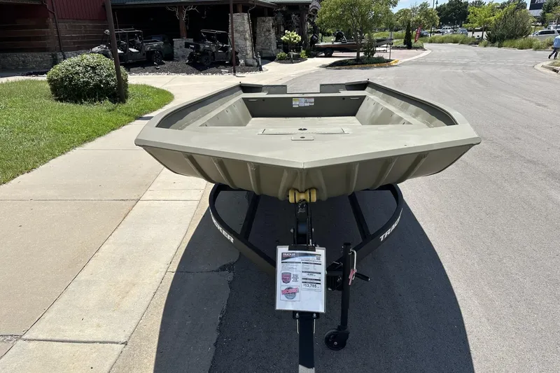 Slide: The Image of 2025 Tracker Grizzly 2072 Utility boat on trailer, parked outdoors on a sunny day. - 31