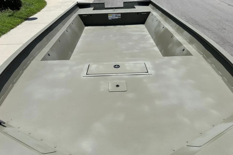 Slide: The Image of 2025 Tracker Grizzly 2072 Utility boat interior, showcasing spacious, durable design on a sunny day. - 8