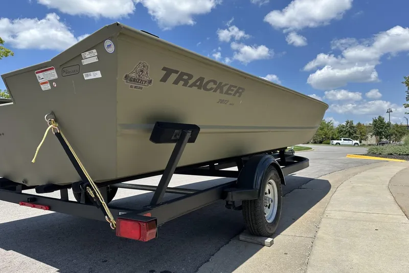 Slide: The Image of 2025 Tracker Grizzly 2072 Utility boat on trailer under blue sky. - 3