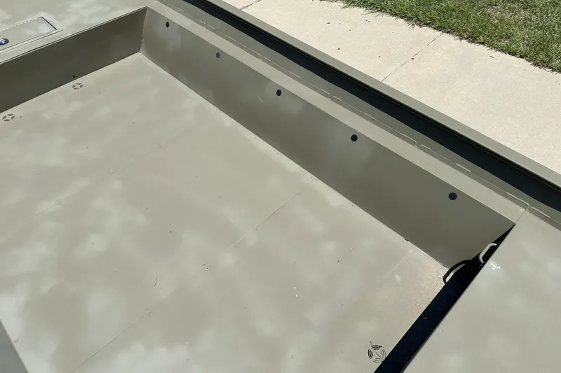 Slide: The Image of 2025 Tracker Grizzly 2072 Utility boat interior, showcasing spacious, durable design on a sunny day. - 7