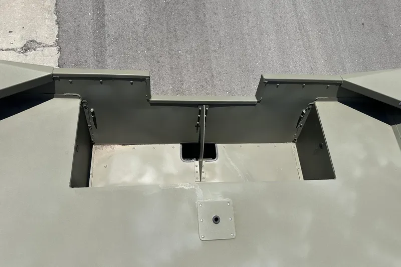 Slide: The Image of Top view of 2025 Tracker Grizzly 2072 Utility boat's open compartments on a paved surface. - 10