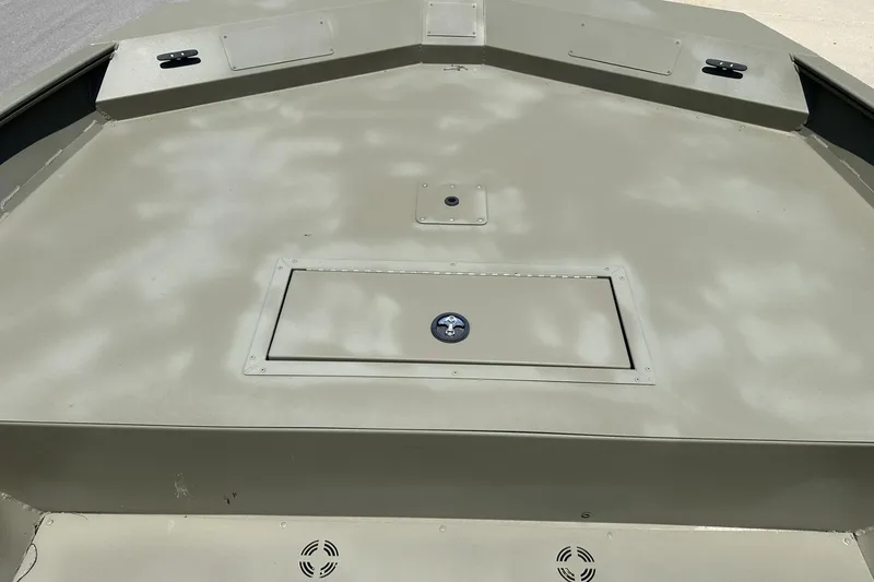 Slide: The Image of 2025 Tracker Grizzly 2072 Utility boat deck, featuring storage compartment and cleats. - 5