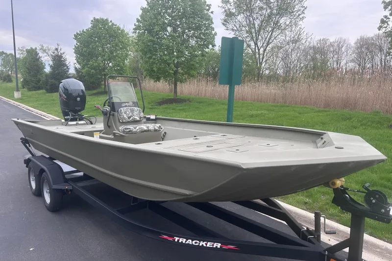 The Image of 2024 Tracker Grizzly 2072 CC boat on trailer, parked outdoors. - 0