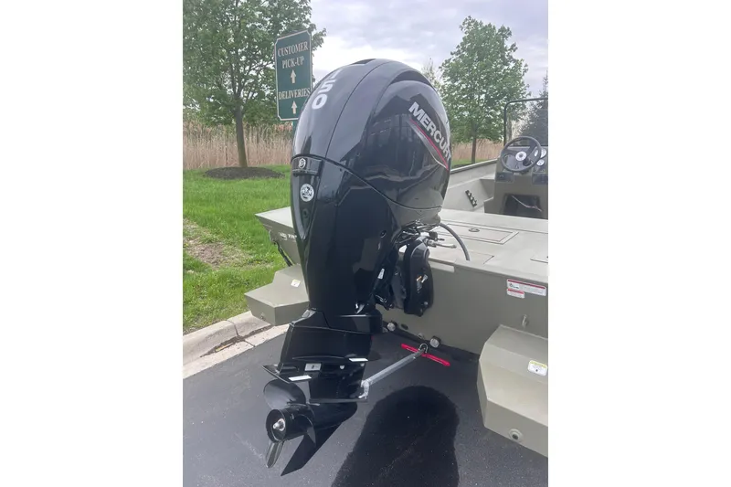 Slide: The Image of 2024 Tracker Grizzly 2072 CC boat with Mercury outboard motor in parking lot. - 10