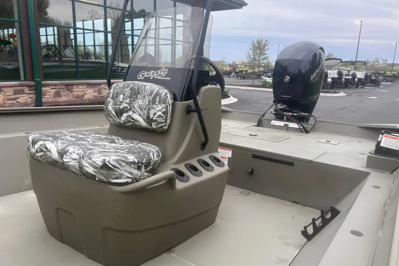 Slide: The Image of 2024 Tracker Grizzly 2072 CC boat with camo seats and Mercury outboard motor. - 16
