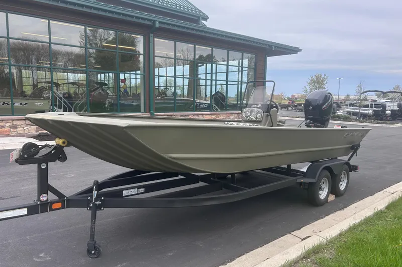Slide: The Image of 2024 Tracker Grizzly 2072 CC boat on trailer outside showroom. - 19