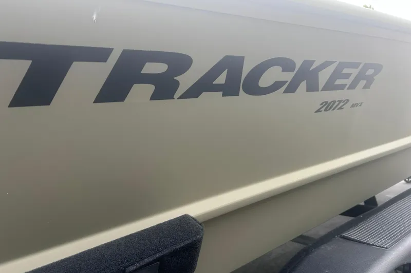 Slide: The Image of 2024 Tracker Grizzly 2072 CC boat side view with logo and model details. - 20