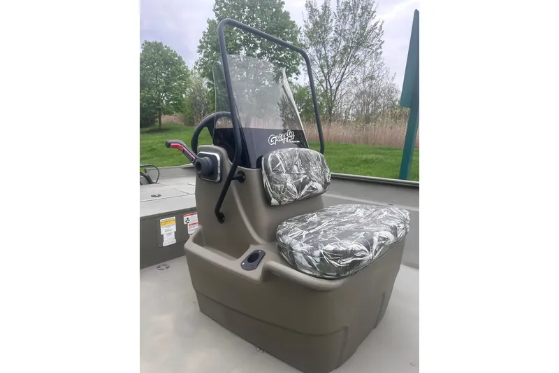 Slide: The Image of 2024 Tracker Grizzly 2072 CC boat console with camouflage seat covers. - 4