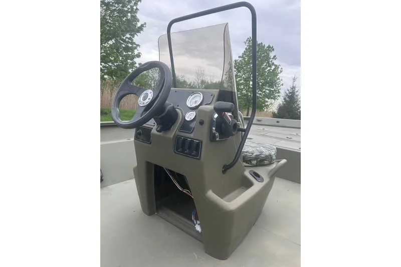 Slide: The Image of 2024 Tracker Grizzly 2072 CC boat console with steering wheel and gauges. - 6