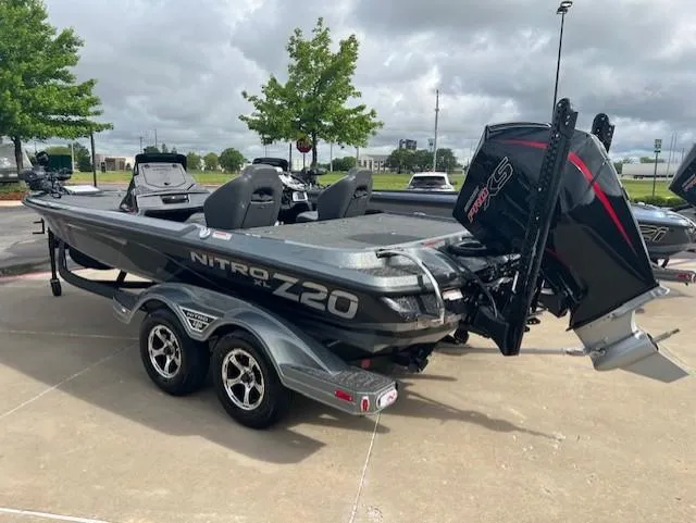 Slide: The Image of 2025 Nitro Z20 XL Pro boat with dual seats and powerful engine, parked outdoors. - 2