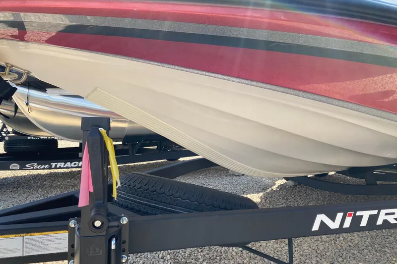Slide: The Image of 2025 Nitro Z20 XL Pro boat on trailer, red and white hull, Sun Tracker branding. - 16