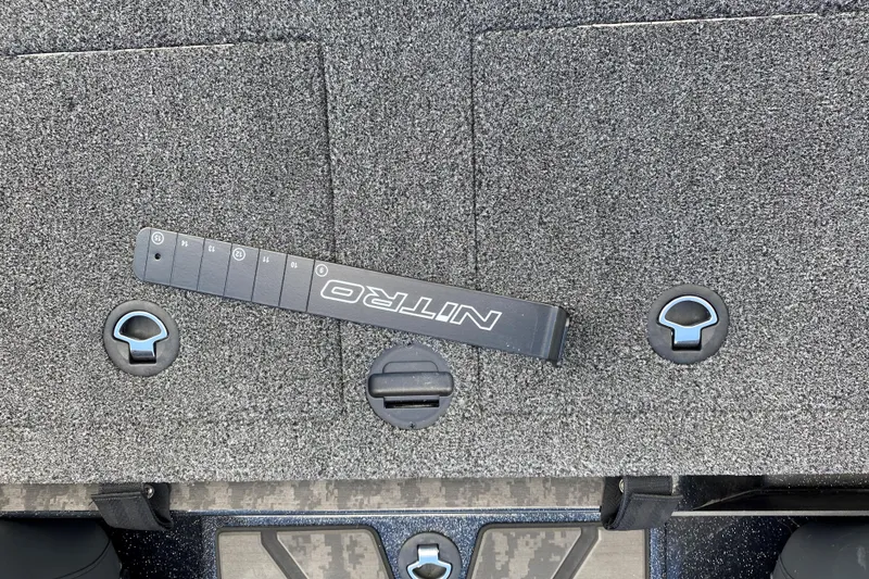 Slide: The Image of 2025 Nitro Z20 XL Pro boat deck with storage compartments and measuring tool. - 18