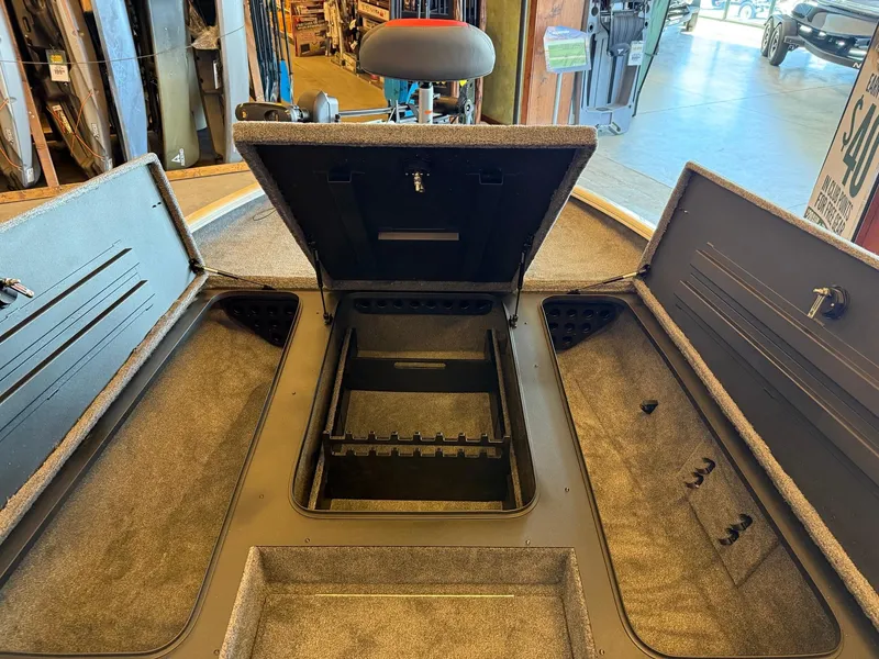 Slide: The Image of 2025 Tracker Savage 215 boat interior with open storage compartments and seating. - 6