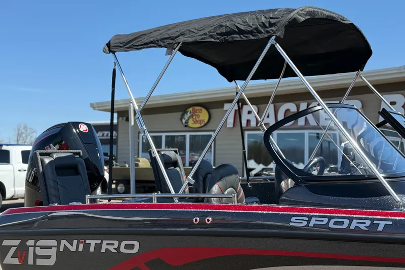 Slide: The Image of 2024 Nitro ZV19 Sport Pro boat with canopy, displayed outside a dealership. - 5
