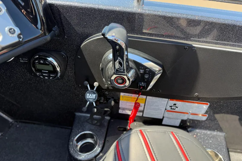 Slide: The Image of 2024 Nitro ZV19 Sport Pro boat control panel with throttle and cup holder. - 7