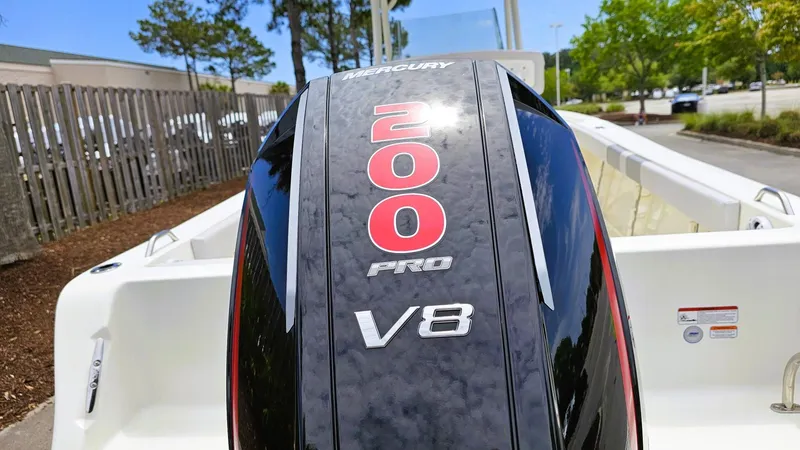 Slide: The Image of 2024 Mako 214 CC boat with Mercury 200 Pro V8 engine in a parking lot. - 15