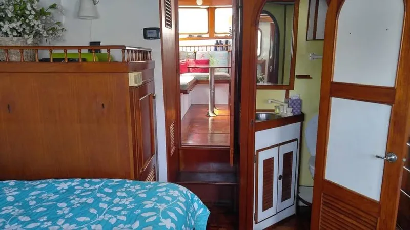 Slide: The Image of Interior of 1979 Universal Marine 41 yacht with cozy cabin and wooden furnishings. - 10