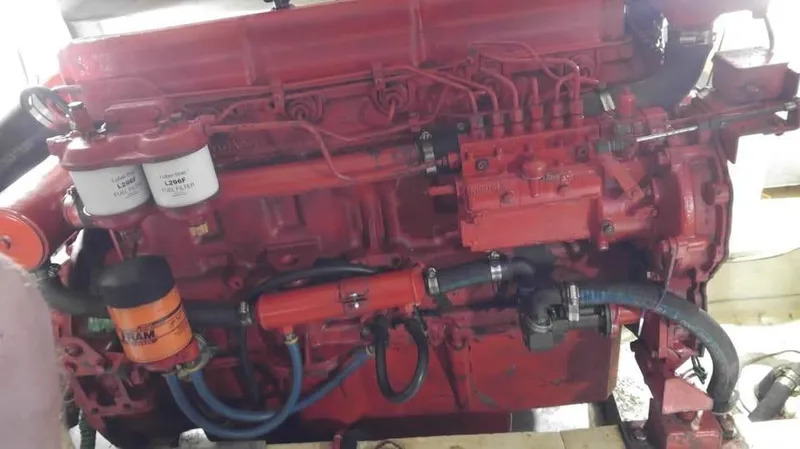 Slide: The Image of Red Universal Marine 41 engine from 1979 with visible filters and hoses. - 17